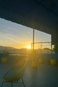 a patio with a table and chairs and the sunset at Casa Voyager 'secret garden terrace' in Chefchaouen