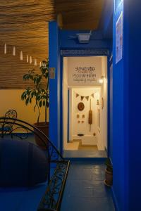 a room with a blue door with a sign on it at Casa Voyager 'secret garden terrace' in Chefchaouen