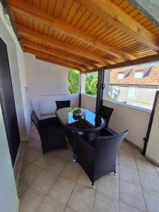 a dining room with a table and chairs at Apartments Milevčić in Jelsa