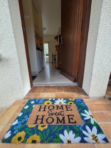a home sweet home rug on the floor in a hallway at StudiosMichel apt 17 balcon thermes 400m à pied in Cazaubon