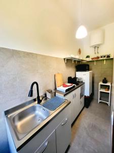 a kitchen with a sink and a counter top at Casa Siria in Livorno +1 photo