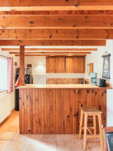 a kitchen with wooden cabinets and a counter top at Cottage Batz - Moulin de Kerellec in Plougoulm