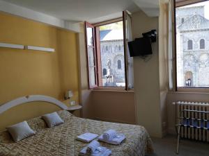 Postel nebo postele na pokoji v ubytování Hôtel restaurant Notre Dame