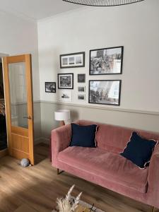 a living room with a couch and pictures on the wall at Harbour quay in Wick