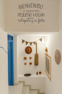 a room with a guitar on a wall with a sign on the ceiling at Casa Voyager 'secret garden terrace' in Chefchaouen