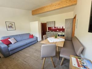 a living room with a couch and a table at Versigglhof in Appiano sulla Strada del Vino