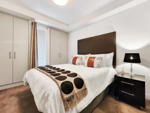 a bedroom with a large bed and a window at Birds-eye canal view - Walk to CTICC and V&A Waterfront! in Cape Town
