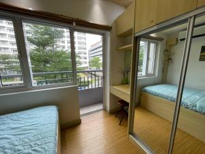 Postel nebo postele na pokoji v ubytování SMDC GRACE RESIDENCIES
