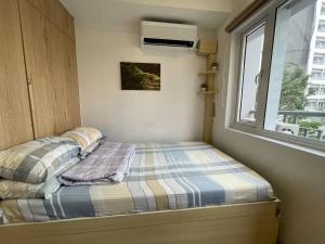 Postel nebo postele na pokoji v ubytování SMDC GRACE RESIDENCIES