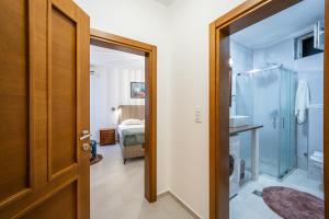 a bathroom with a shower and a door to a bedroom at Guest House Medin in Petrovac na Moru +172 photos