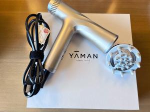 a hair dryer sitting on top of a white paper at Hotel Monterey Akasaka in Tokyo