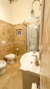 a bathroom with a white sink and a toilet at Pantheon Luxury Noble Apartment in Rome +31 photos