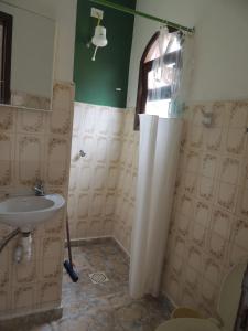 a bathroom with a sink and a shower at Chale Colonial in Ubatuba