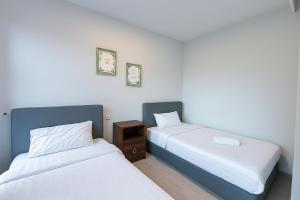 Postel nebo postele na pokoji v ubytování ENDLESS SUMMER Jesselton Quay Kota Kinabalu 來繕旅遊