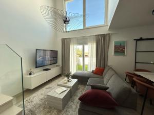 a living room with a couch and a large window at Villa Maksan - Sea View, Jacuzzi & BBQ Garden in Pakoštane
