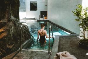 a woman in a swimming pool at Le Berceau de La Source in Bagnères-de-Bigorre