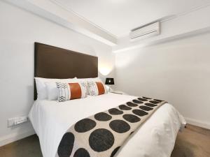 a bedroom with a large white bed in a room at Birds-eye canal view - Walk to CTICC and V&A Waterfront! in Cape Town