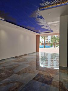a room with a blue ceiling and a stone floor at AURORA Apartment Shëngjin Kune in Shëngjin