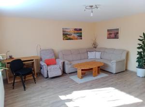a living room with a couch and two chairs and a table at Ferienwohnung Rackl in Furth im Wald
