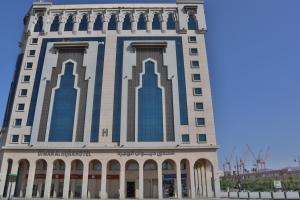 a tall building with blue and white at فندق ديوان الهجرة in Medina