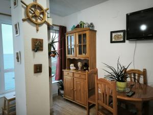 a dining room with a table and a clock on the wall at Ensenada Dichosa in Suances