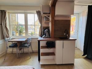 a kitchen with a desk and a table in a room at My Home in Harlingen