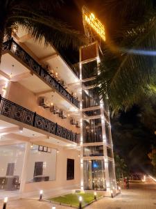 a large white building with a lit up facade at night at Mango Mansion in Jaffna