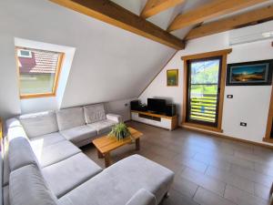 a living room with a couch and a table at Apartma Tima in Bovec