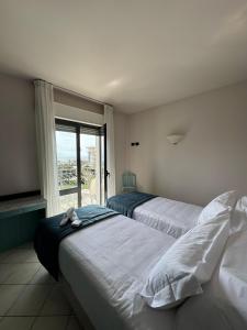 Postel nebo postele na pokoji v ubytování Hotel Harmony-Smile