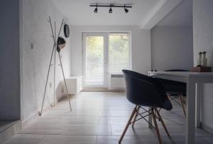 a room with a table and chairs and a window at Студио Черно и Бяло in Sandanski