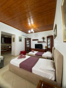 a bedroom with two beds and a fireplace at FarmHouse Qeparo in Qeparo