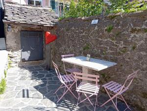 a table and chairs with a heart on the wall at Ortacolorhome BlueHome-Boleto in Madonna del Sasso