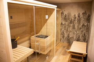 a sauna with wooden floors and a wall with a wallpaper at B&B LE TERZE - Wellness & SPA - E-bike rental in Costalta +32 photos