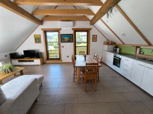 a kitchen and dining room with a table and a couch at Apartma Tima in Bovec