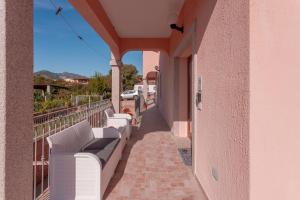 a balcony with white benches on a building at Domo Davide in San Teodoro
