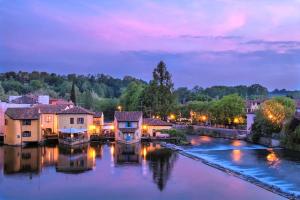 a river with houses and a town at night at Casa Magenta Apartment 5 in Valeggio sul Mincio
