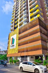 a white car parked in front of a building at Lotus Luxe Residences in Kirillapone