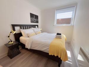 エディンバラにあるQuiet 2 bedrooms and 2 bathrooms with free parkingのベッドルーム1室(黄色い毛布付きのベッド1台付)