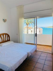 a bedroom with a bed and a view of the ocean at Beach house with pool at the Fortí viewpoint in Altafulla
