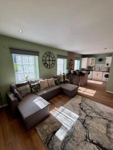 a living room with a couch and a kitchen at The Wheel House - Private Front door and Free Parking in Edinburgh