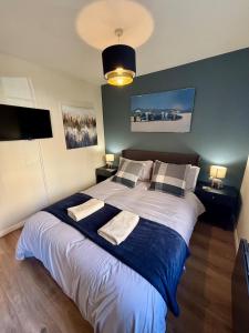 a bedroom with a large bed with two pillows at The Wheel House - Private Front door and Free Parking in Edinburgh
