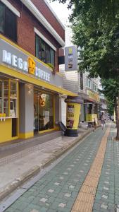 a city street with some stores and a sidewalk at Million House in Seoul