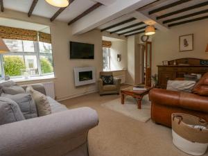 a living room with a couch and a table at Fox Barn in Kendal