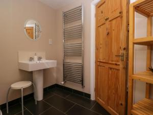 a bathroom with a sink and a mirror at Fox Barn in Kendal +36 photos
