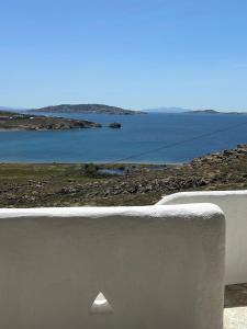 a white wall with a view of the water at Blue and White Mykonos ap2 in Mikonos