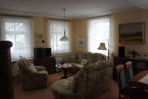 a living room with a couch and chairs and a table at apartment Anna in Wilthen