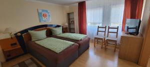 a bedroom with a bed and a television in a room at Ferienhaus grüne Oase in Halle an der Saale