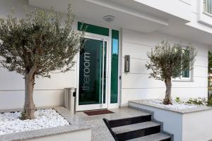 a building with two trees in front of a door at The Room Hotel & Apartments in Antalya