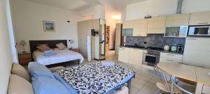 a kitchen with a couch and a table in a room at Villa gli Ulivi Chalten Apartment in Perledo