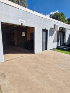 a garage with a garage door open on a building at Toekoms Inn in Aliwal North